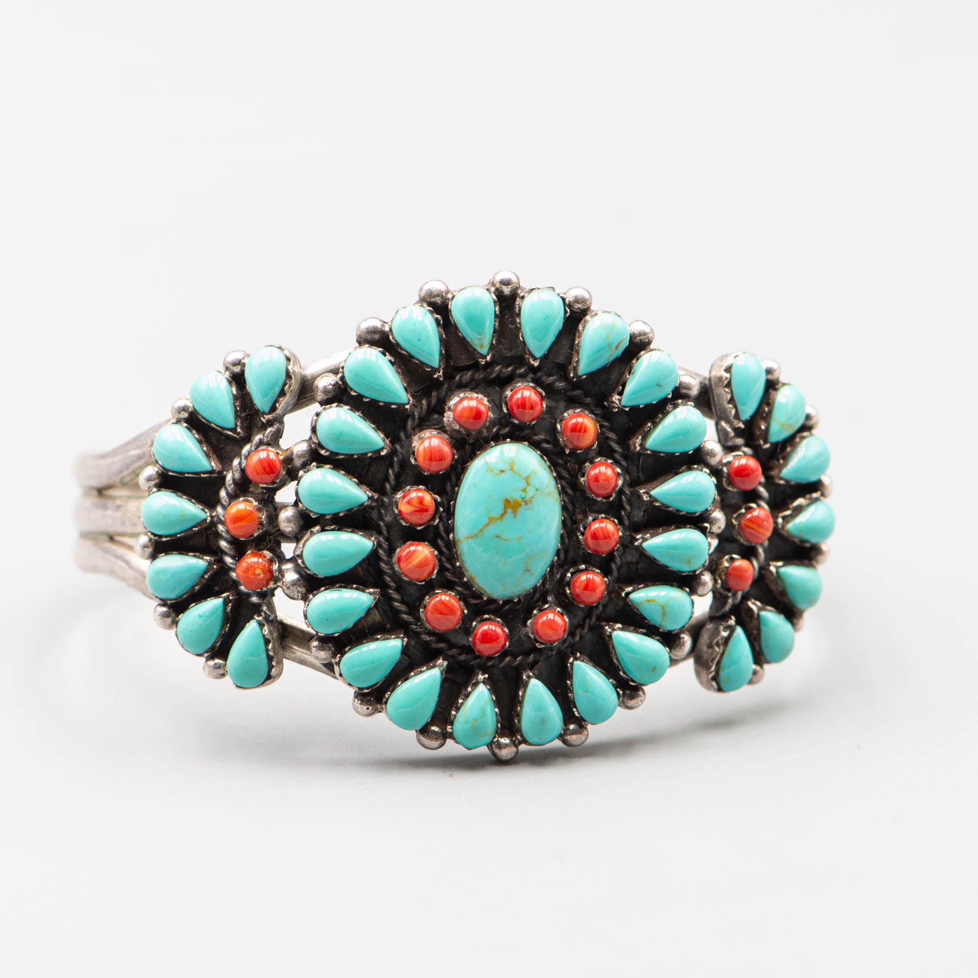 Native American silver cuff adorned with turquoise cabochon and coral cabochon