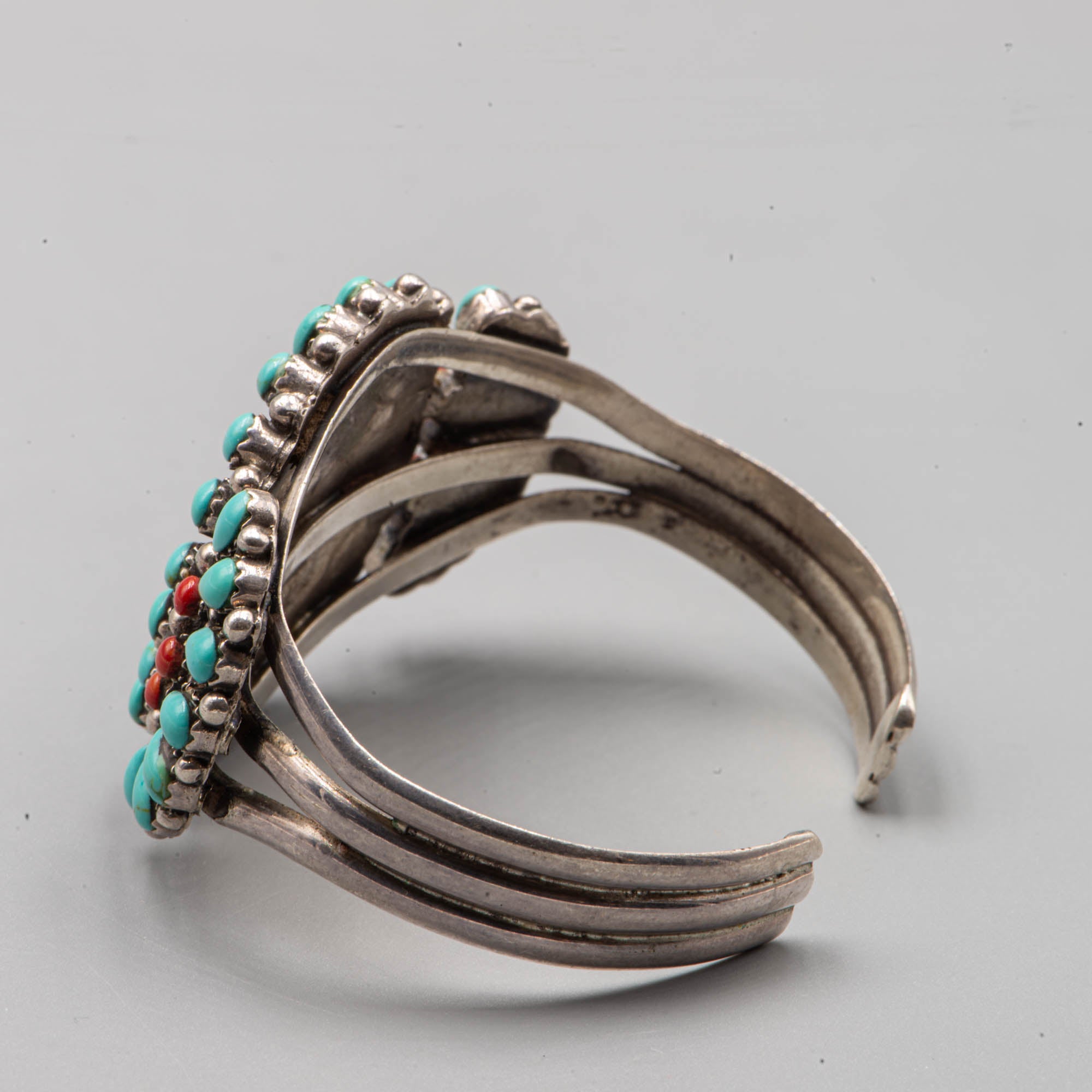 Native American silver cuff adorned with turquoise cabochon and coral cabochon