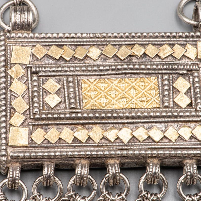 Close-up of Omani silver Hirz amulet box with gold plaque