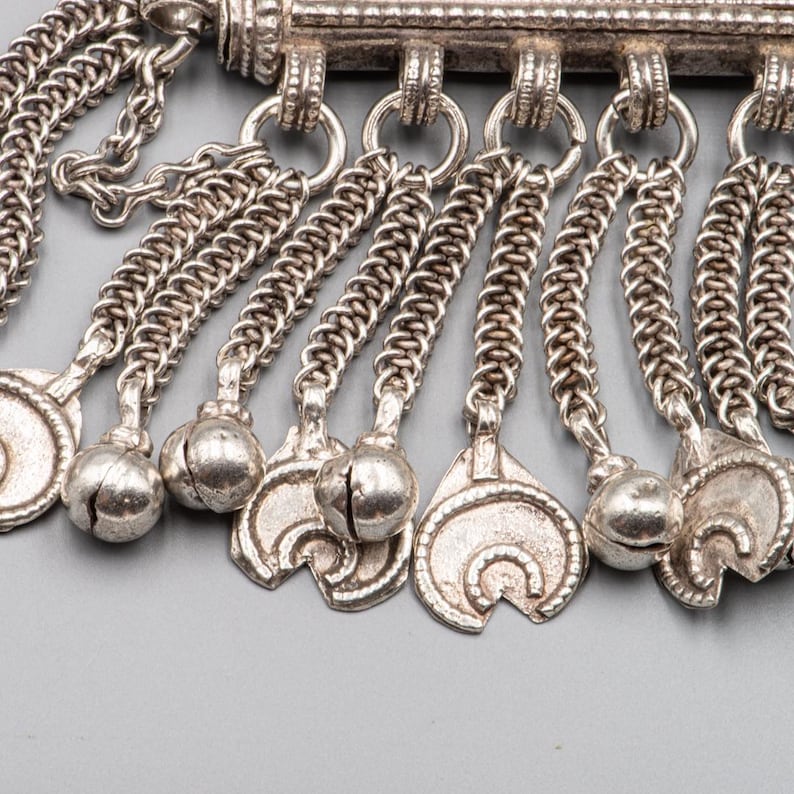 Detail of dangling silver charms on Omani Hirz necklace